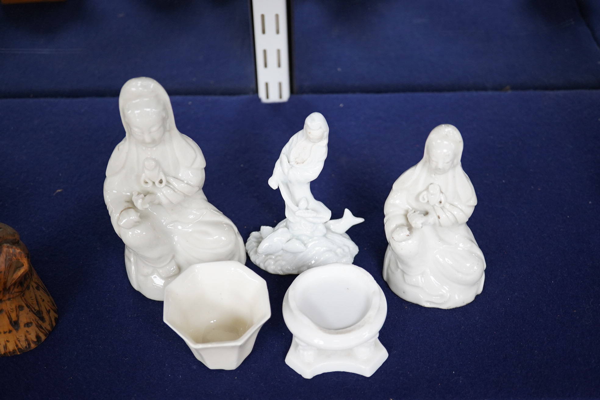 Three blanc de chine figures, one octagonal blanc de chine cup and a similar stand, largest 15cm high. Condition - good, stand is poor